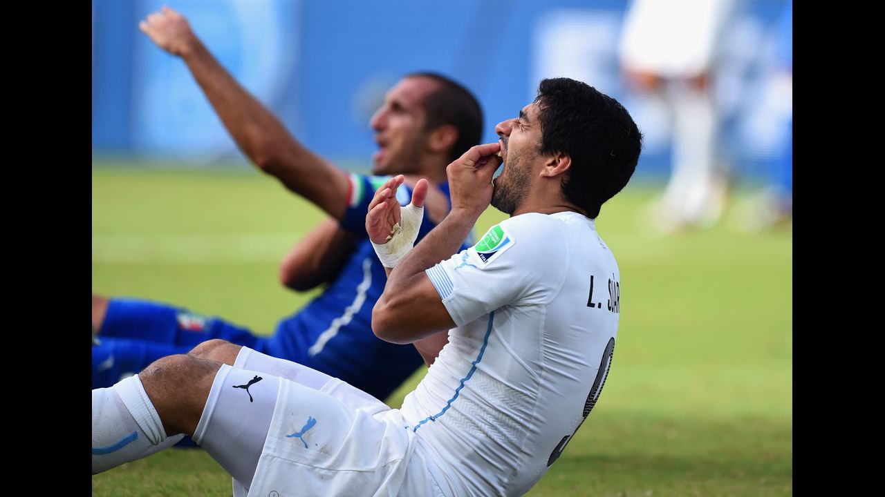 Suarez holds his mouth as Chiellini sits in the background. Suarez will now face a nervous wait to find out if football's world governing body FIFA will take action retrospectively -- given it was missed by the match officials -- and punish him.