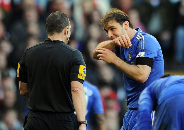 Ivanovic demonstrates the bite he received from Suarez to a referee.