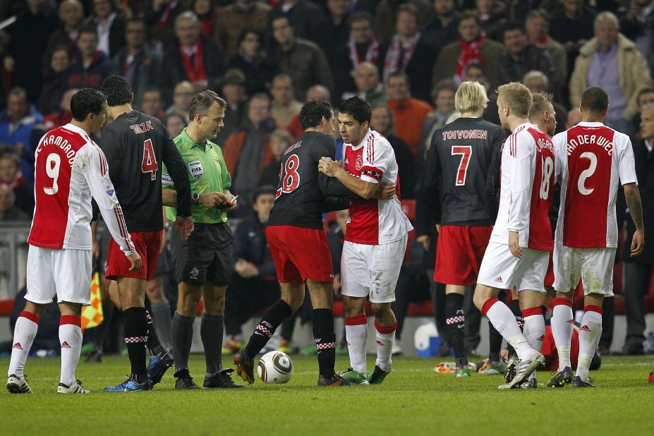 During his time in the Netherlands with Ajax in 2011, Suarez was banned for seven games after leaving a scar on the collarbone of Amsterdam player Otman Bakkal.