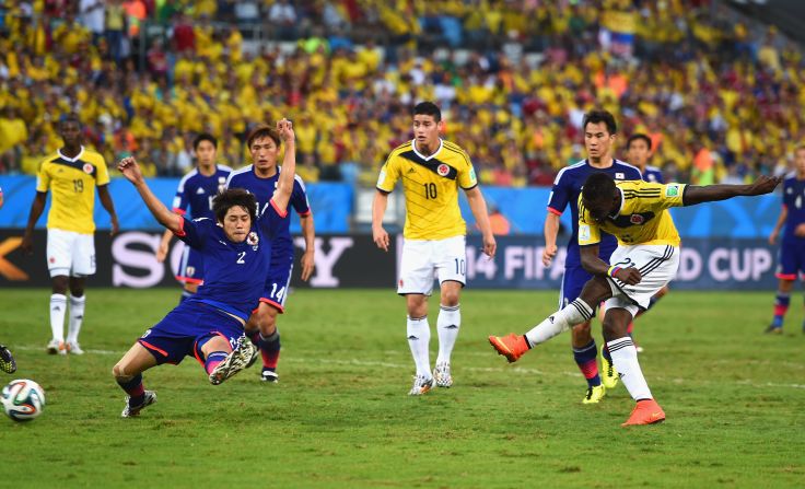 Jackson Martinez of Colombia shoots and scores his team's second goal against Japan.