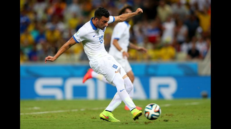 Andreas Samaris of Greece scores against the Ivory Coast.