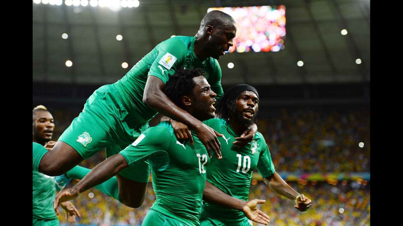 Wilfried Bony of the Ivory Coast celebrates scoring his team's first goal with Yaya Toure, left, and Gervinho.