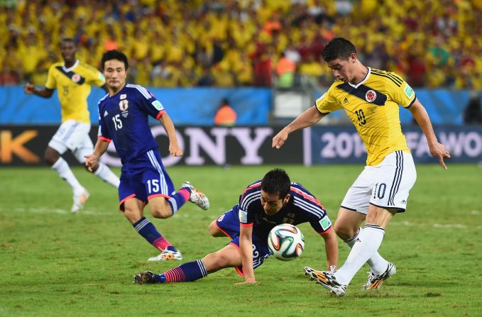 James Rodriguez of Colombia shoots and scores his team's fourth goal against Japan on June 24 in Cuiaba, Brazil. Colombia won 4-1.