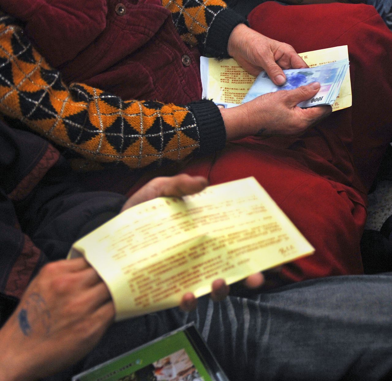Two people count banknotes at a charity event held in Taiwan by Chen in 2011. 
