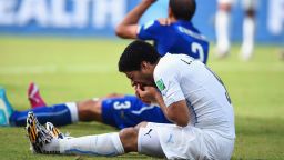 NATAL, BRAZIL - JUNE 24: Luis Suarez of Uruguay and Giorgio Chiellini of Italy react after a clash during the 2014 FIFA World Cup Brazil Group D match between Italy and Uruguay at Estadio das Dunas on June 24, 2014 in Natal, Brazil. (Photo by Matthias Hangst/Getty Images)