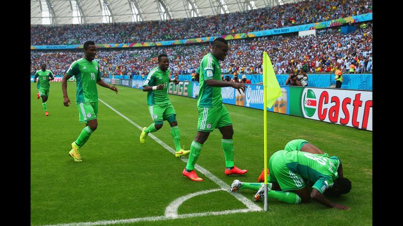 Ahmed Musa of Nigeria celebrates scoring his team's first goal with teammates during a match between Nigeria and Argentina at Estadio Beira-Rio in Porto Alegre, Brazil.  