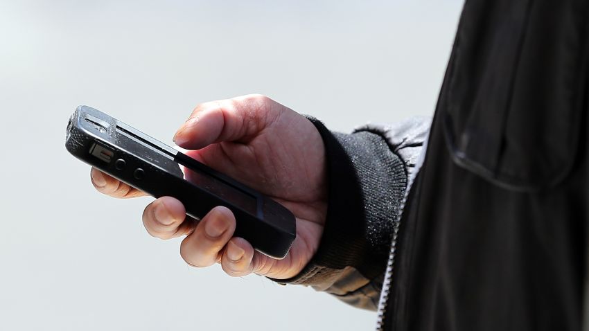 SAN FRANCISCO, CA - JUNE 05:  A pedestrian uses a smartphone as he walks along Market Street on June 5, 2013 in San Francisco, California.  According to a study by the Pew Internet & American Life Project, over half of American adults, or 56 percent, have smartphones, up from 35 percent two years ago.  (Photo by Justin Sullivan/Getty Images)