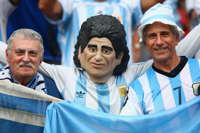 Maradona no se podía perder el partido. Un fanático con una máscara del astro argentino posa para las cámaras de los medios.