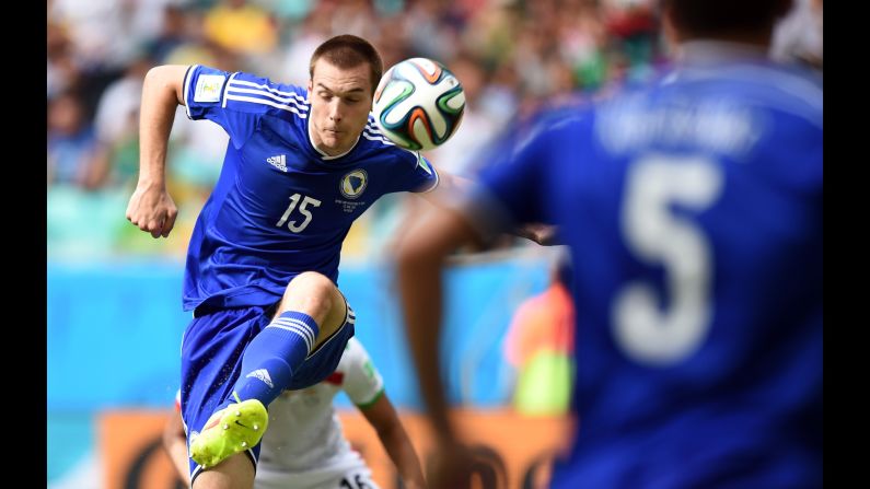 Bosnia-Herzegovina's defender Toni Sunjic, left, in action during a match against Iran at Arena Fonte Nova in Salvador, Brazil.  