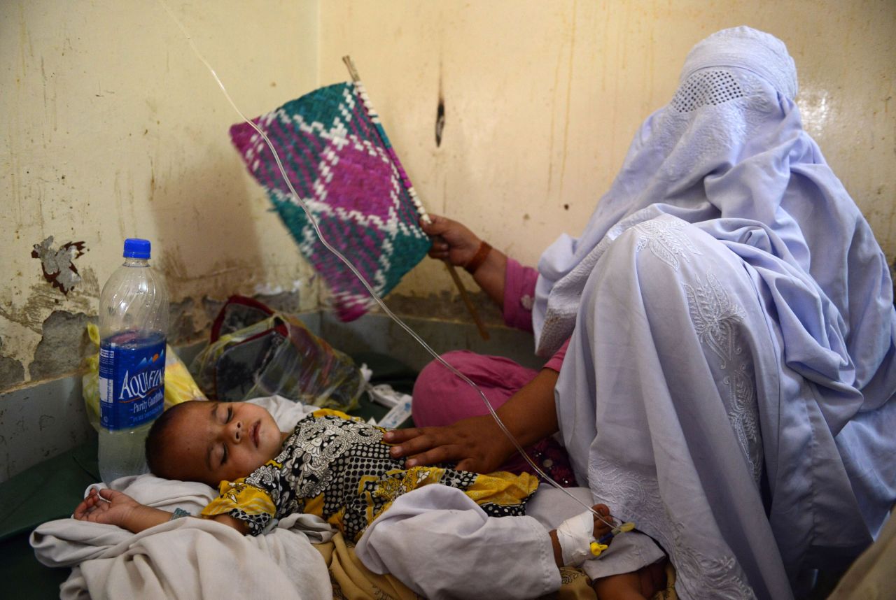 A displaced Pakistani woman takes care of her sick child at the Women and Children Hospital in Bannu on June 21. 