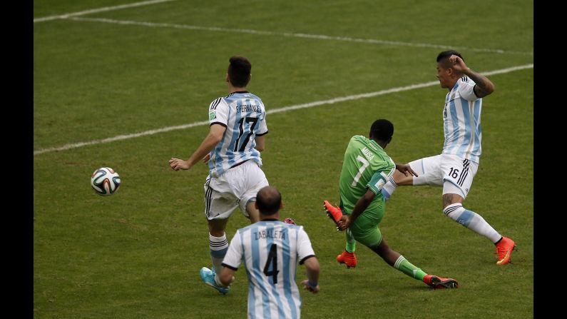 Nigeria's forward Ahmed Musa scores his second goal past Argentina's defender Federico Fernandez, left, and Argentina's defender Marcos Rojo. 
