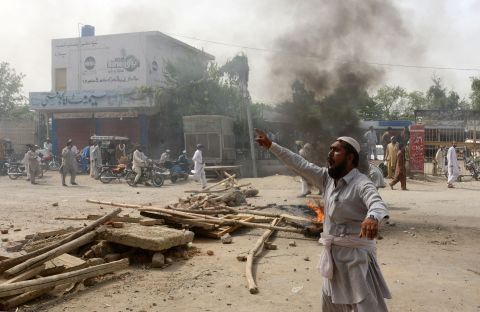 A displaced Pakistani civilian protests against the food shortage. Many expressed anger anger at the long delays.