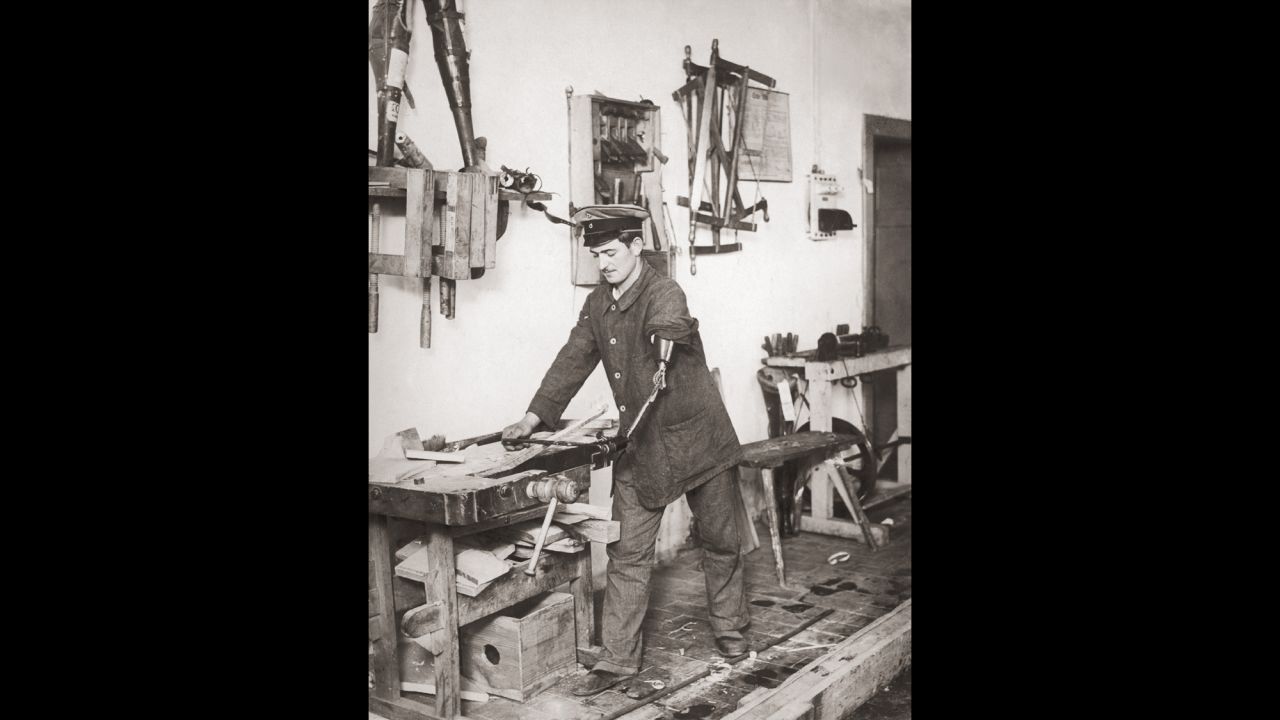 A disabled German ex-serviceman works as a carpenter with the aid of a prosthetic arm, Germany, circa 1919.