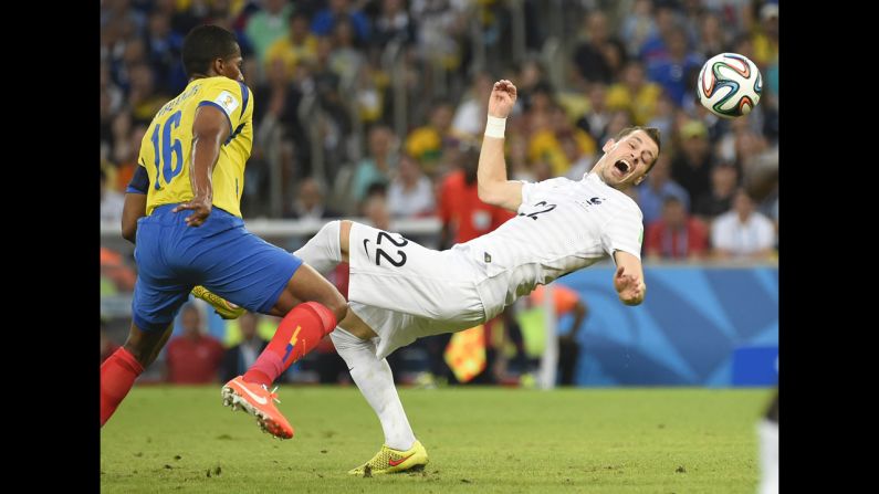 France's Morgan Schneiderlin, right, is challenged by Ecuador's Antonio Valencia.