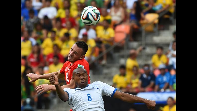 Switzerland forward Josip Drmic, top, vies with Honduras midfielder Wilson Palacios.