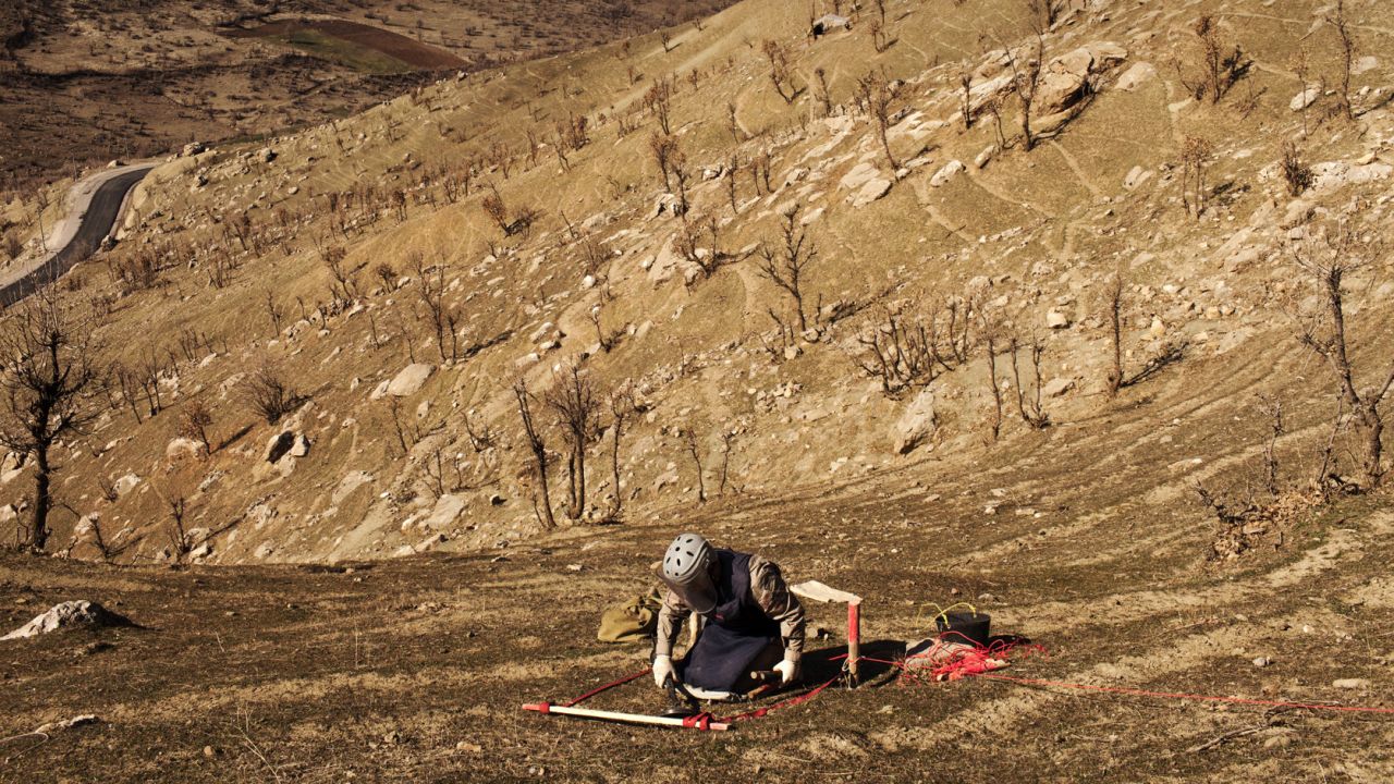 A deminer from Iraqi Kurdistan Mine Action Agency practices next to a mine field in the Iraqi village of Mawilian. The mines were placed by the Iraqi Army during the Iraq-Iran war in the 1980s. Marco di Lauro, who photographed the Iraq War in 2003, returned in 2014 to document the country's struggles with landmines.