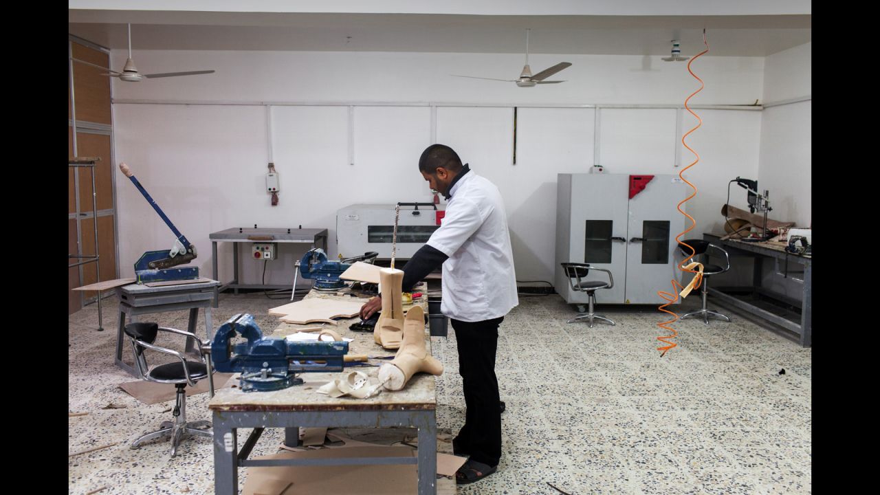 A technician manufactures prosthetics at the rehabilitation center in Najaf.