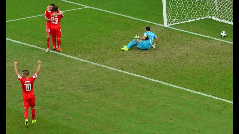 Switzerland midfielder Xherdan Shaqiri, third from left, celebrates with forward Josip Drmic next to Honduras' goalkeeper Noel Valladares after scoring his team's third goal against Honduras in Manaus, Brazil, on Wednesday, June 25. Switzerland won 3-0.