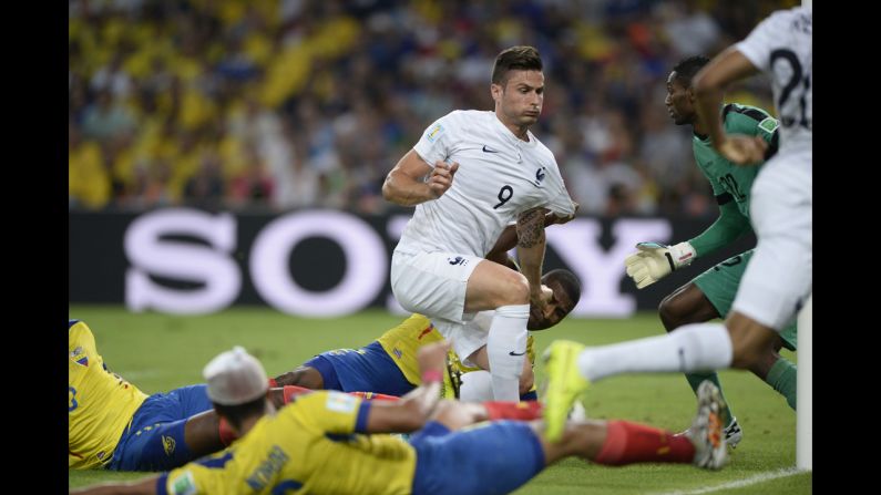 France's Olivier Giroud, center misses a goal attempt against Ecuador.