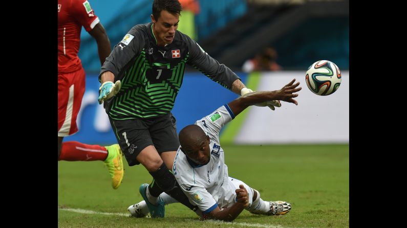 Switzerland's goalkeeper Diego Benaglio, left, challenges Switzerland's Goekhan Inler.