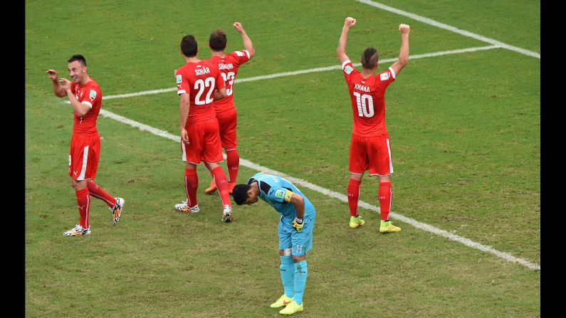 Honduras' goalkeeper Noel Valladares, front, reacts as Switzerland celebrates its third goal.