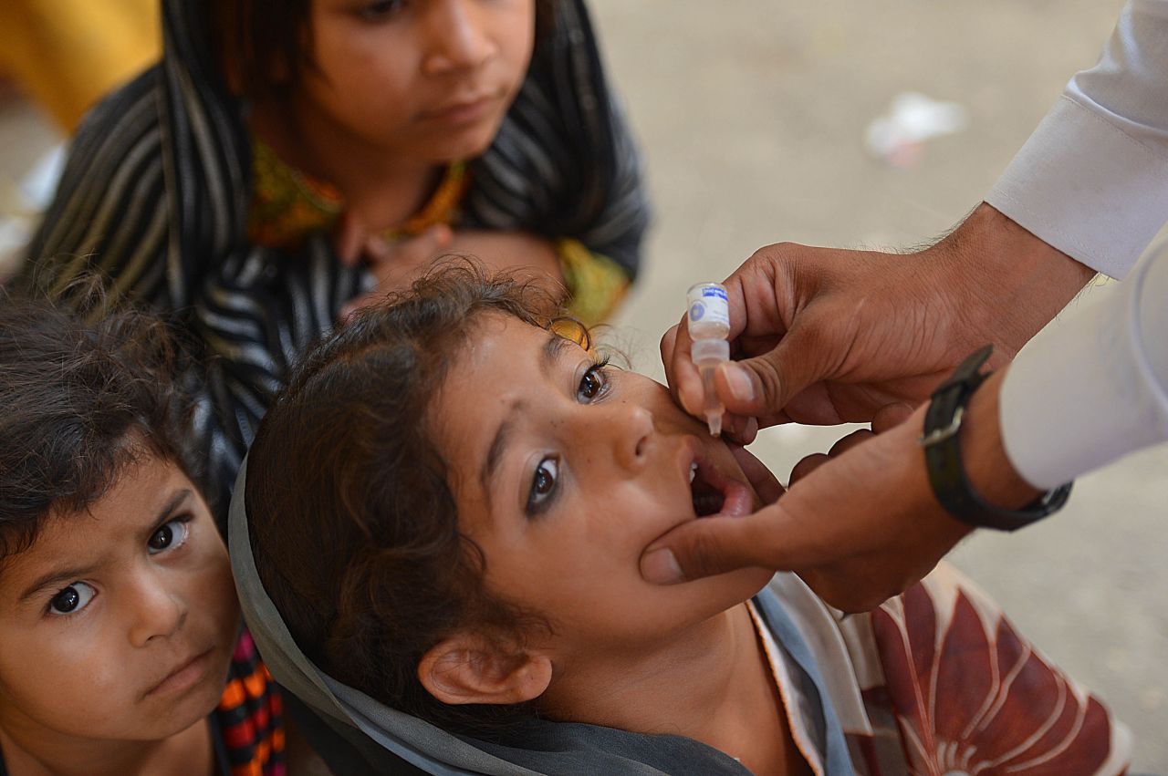 A Pakistani health worker gives a dose of polio vaccine to a child in Bannu on June 25. The World Health Organization has launched a campaign to stop the spread of the illness as hundreds of thousands of people flee North Waziristan.