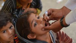 Pakistani health worker administers the polio vaccine to a child during a vaccination campaign in Bannu on June 25, 2014. Pakistan launched a fresh polio vaccination drive in its restive tribal belt late last month, but officials warned that nearly 370,000 children are likely to miss out because of security problems. Pakistan's seven semi-autonomous tribal areas along the Afghan border are the epicentre of the country's polio cases and the government has set up checkpoints to ensure anyone leaving the belt is immunised.