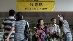 People get information outside a polling station in Hong Kong on June 22, 2014. Physical booths opened for Hong Kong's unofficial referendum on democratic reform after more than half a million had voted online, as Beijing warned the vote is illegal. AFP PHOTO / Philippe Lopez (Photo credit should read PHILIPPE LOPEZ/AFP/Getty Images)