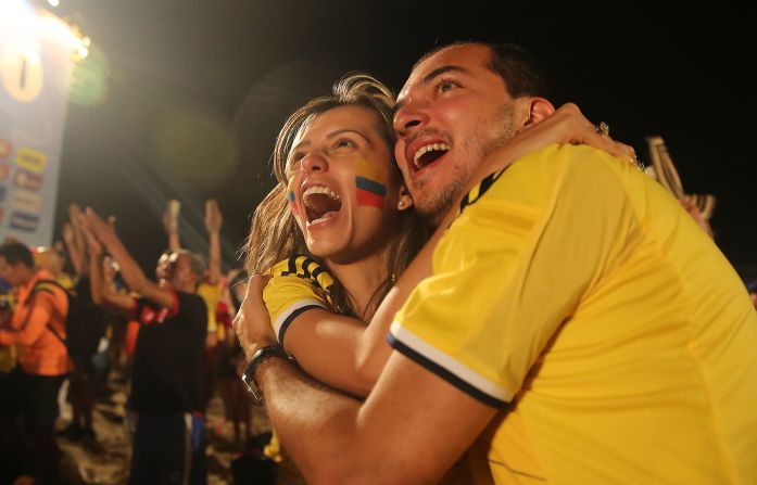 Colombia supporters at the FIFA Fan Fest on Copacabana Beach embrace and celebrate a World Cup win over Japan on Tuesday, June 24.