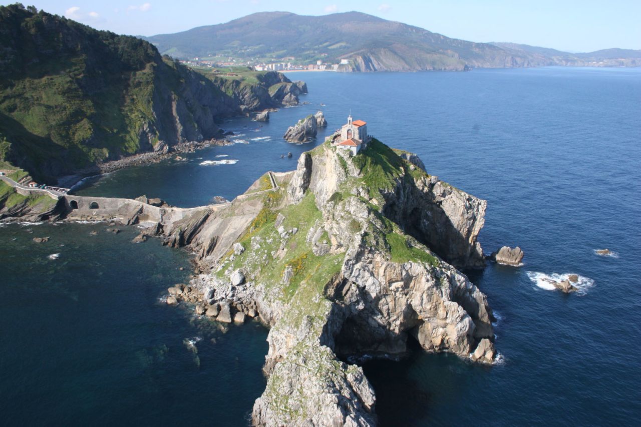 Gaztelugatxe, a small, rocky island on Spain's northern coast is said to resemble a castle, which could explain why it's suffered numerous attacks over the centuries. Connected to the mainland by a causeway, the island's main highlight is a chapel built in the 11th century in honor of St. John. 