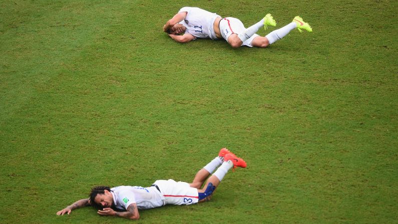 Jermaine Jones, front, of the United States and teammate Alejandro Bedoya lie on the field after colliding during a match against Germany.