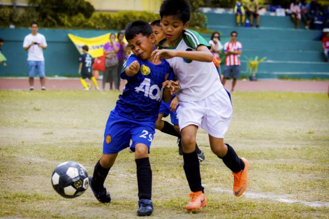 These kids "have their game faces on" as they <a href="index.php?page=&url=http%3A%2F%2Fireport.cnn.com%2Fdocs%2FDOC-1136525">fight for the ball</a> in Cebu, Philippines, says Clarson Fruelda. They're playing in an annual local soccer tournament with divisions for all ages.