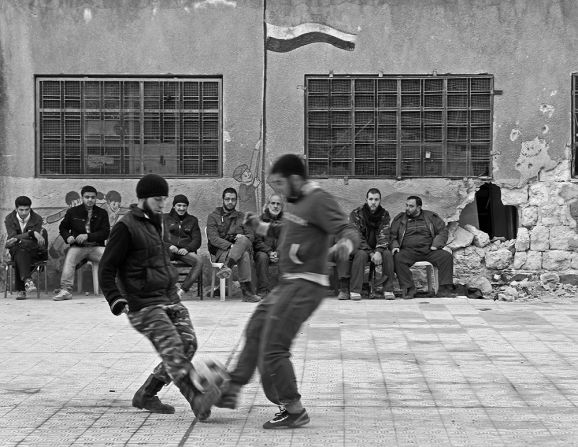 A group of Free Syrian Army fighters in Aleppo, Syria, takes a break for a <a href="index.php?page=&url=http%3A%2F%2Fireport.cnn.com%2Fdocs%2FDOC-1143212">quick game of pick-up soccer</a>. Photographer Reynaldo Leal captured the game while documenting the conflict in Syria in 2013.