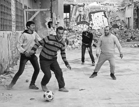 This match took place in the courtyard of an abandoned elementary school in Syria, said Leal. "Everything had been so serious on the front lines that day, so I was surprised to find the fighters playing a pick-up game of football," he said.