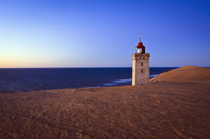 Aggressive sand drift and coastal erosion led to Rubjerg Knude Lighthouse's abandonment in 1968, leaving it looking like the last standing remainder of a ghost town. Although hiking conditions are tough, it's worth going to see this dramatic view while it's still there -- the lighthouse will be consumed by the sand and sea within a decade. <br /><a href="index.php?page=&url=http%3A%2F%2Frubjergknude.dk%2Fengelsk%2Fcover-page%2Ffront-page%2F" target="_blank" target="_blank"><em>Rubjerg Knude</em></a><em>, Strandfogegården, Langelinie 2, Rubjerg, 9480 Løkken, Denmark; +45 9624 1050 </em><br /><a href="index.php?page=&url=http%3A%2F%2Fedition.cnn.com%2F2015%2F02%2F04%2Ftravel%2Fdenmark-sand-dunes%2F"><em>More: Sand dune eats Danish lighthouse</em></a>