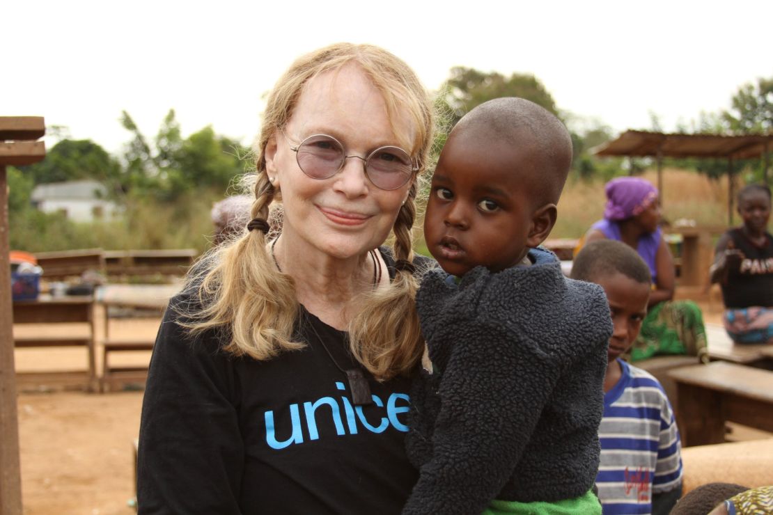 Mia Farrow carries Moussa Ibrahim at the Bossangoa camp in the Central African Republic