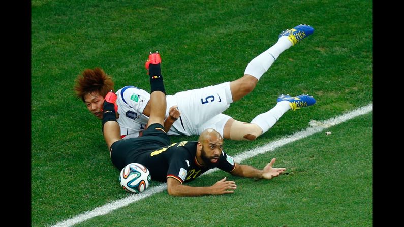 South Korea defender Kim Young-Gwon  and Anthony Vanden Borre of Belgium collide during the match between South Korea and Belgium on June 26 in Sao Paulo, Brazil. 