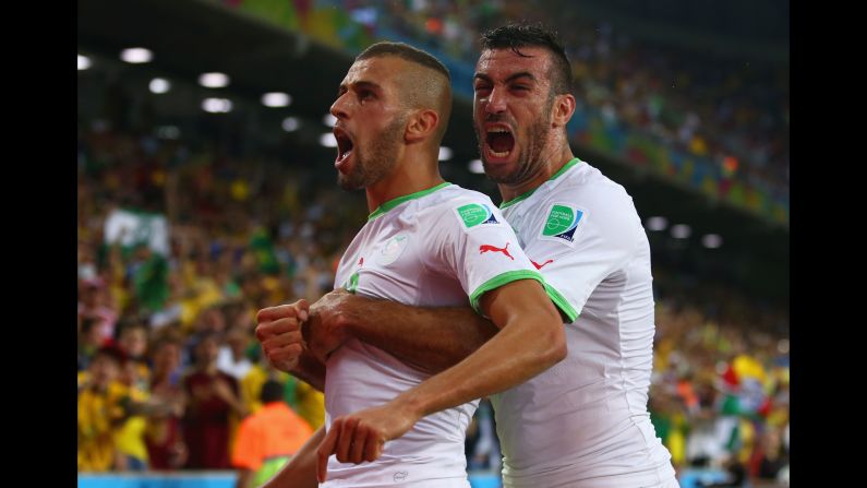 Islam Slimani of Algeria, left, celebrates scoring his team's first goal with Essaid Belkalem.