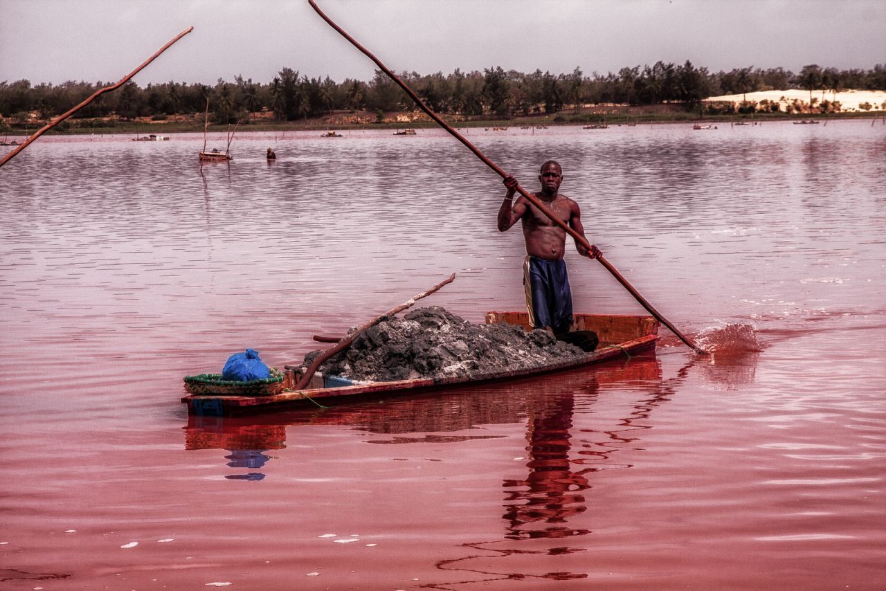 Lake Retba's pink hues are caused by bacteria.