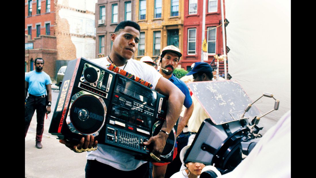 The film is set on a hot day in Brooklyn, New York, and follows the lives of several characters. One of them, Radio Raheem (Bill Nunn), likes to walk around the neighborhood playing Public Enemy's "Fight the Power" at high volume, annoying some and entertaining others. 