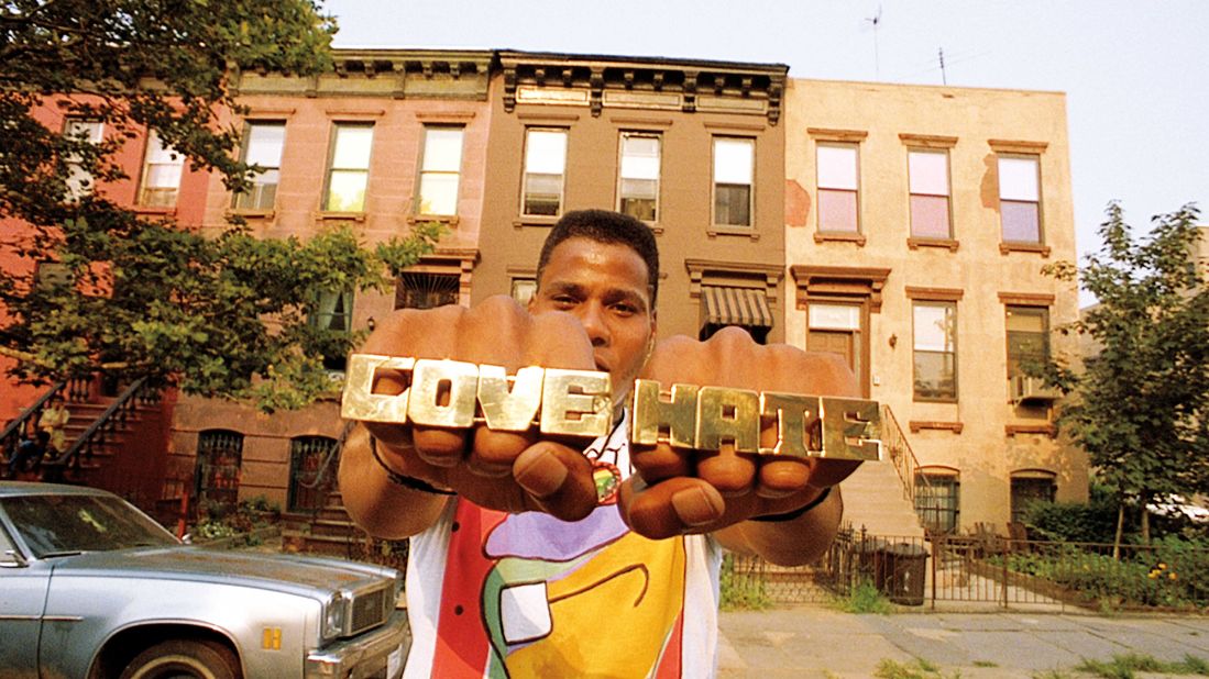 Radio Raheem wears "love" and "hate" on his rings, a reflection of the neighborhood's volatility (and a nod to Robert Mitchum's preacher character in "Night of the Hunter," who has the words tattooed on his knuckles). Another character, a mentally challenged man named Smiley, sells pictures of Malcolm X and the Rev. Martin Luther King Jr., another symbol of duality.