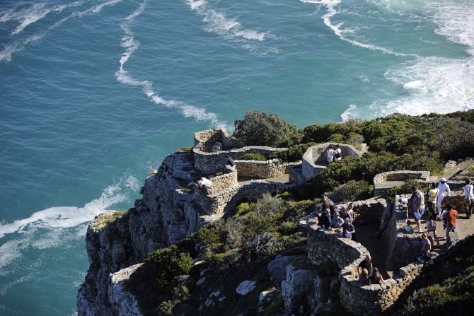 Another stop is the Cape Point, a World Heritage Site whose 200 meter high sheer cliffs cut deep into the mixing waters of Atlantic and Indian Oceans.
