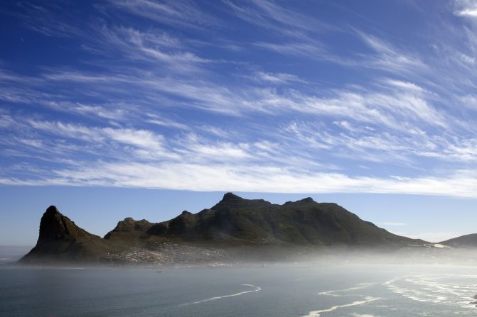 He decided to leave the corporate world after his bank wanted him to relocate, and used the payout from his job to start a new venture as a tour guide. Seen here is the view of Hout Bay Harbor from the Chapman's peak road on the outskirts of Cape Town, one of the stops on Escape to the Cape tour. 