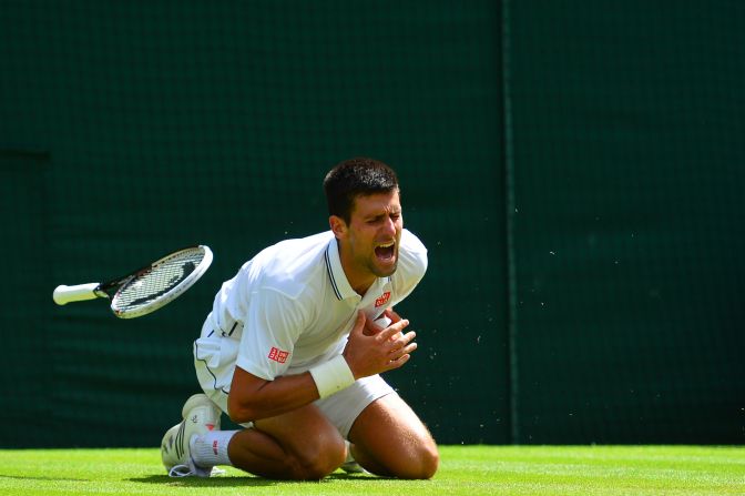 Novak Djokovic clutches his shoulder after an awkward fall during his third round match at Wimbledon.