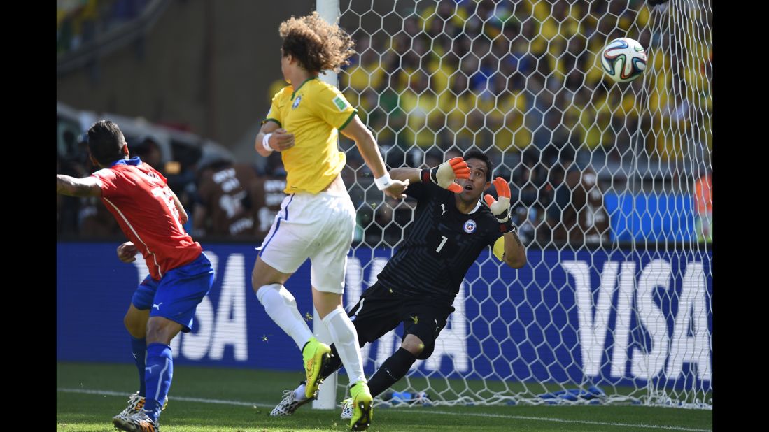 Chile's goalkeeper, Claudio Bravo, can't stop the ball from going in for a Brazil goal. The goal was initially awarded to David Luiz, center, but it was later determined to be an own goal by Chile's Gonzalo Jara.