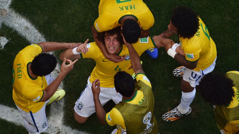 Brazil defender David Luiz is surrounded by teammates after a first-half goal against Chile during a World Cup match Saturday, June 28, in Belo Horizonte, Brazil. The goal was later determined to have gone off Chile's Gonzalo Jara. Brazil won the match on penalty kicks to advance to the quarterfinals.