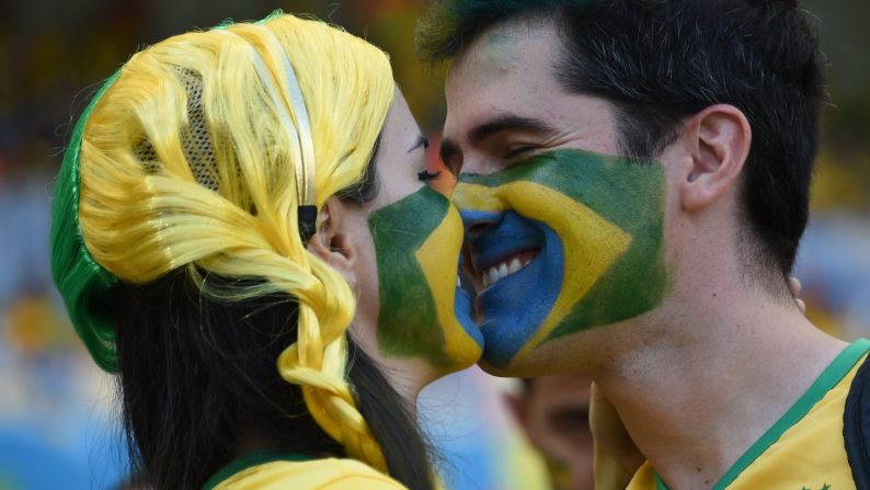 Brazil fans kiss before the start of the game. <a href="index.php?page=&url=http%3A%2F%2Fwww.cnn.com%2F2014%2F06%2F26%2Ffootball%2Fgallery%2Fworld-cup-0626%2Findex.html" target="_blank">See the best World Cup photos from June 26</a>.