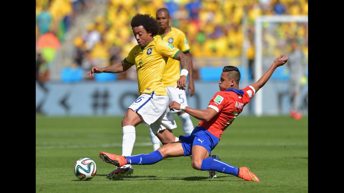 Alexis Sanchez of Chile tackles Marcelo of Brazil.
