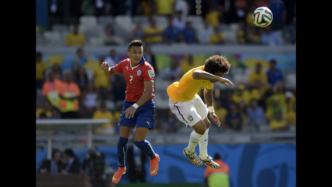 Chile's Alexis Sanchez, left, and Brazil's Marcelo jump for the ball.
