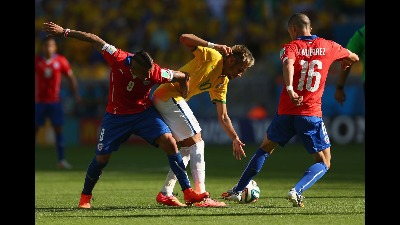 Arturo Vidal of Chile, left, battles for the ball with Neymar of Brazil.